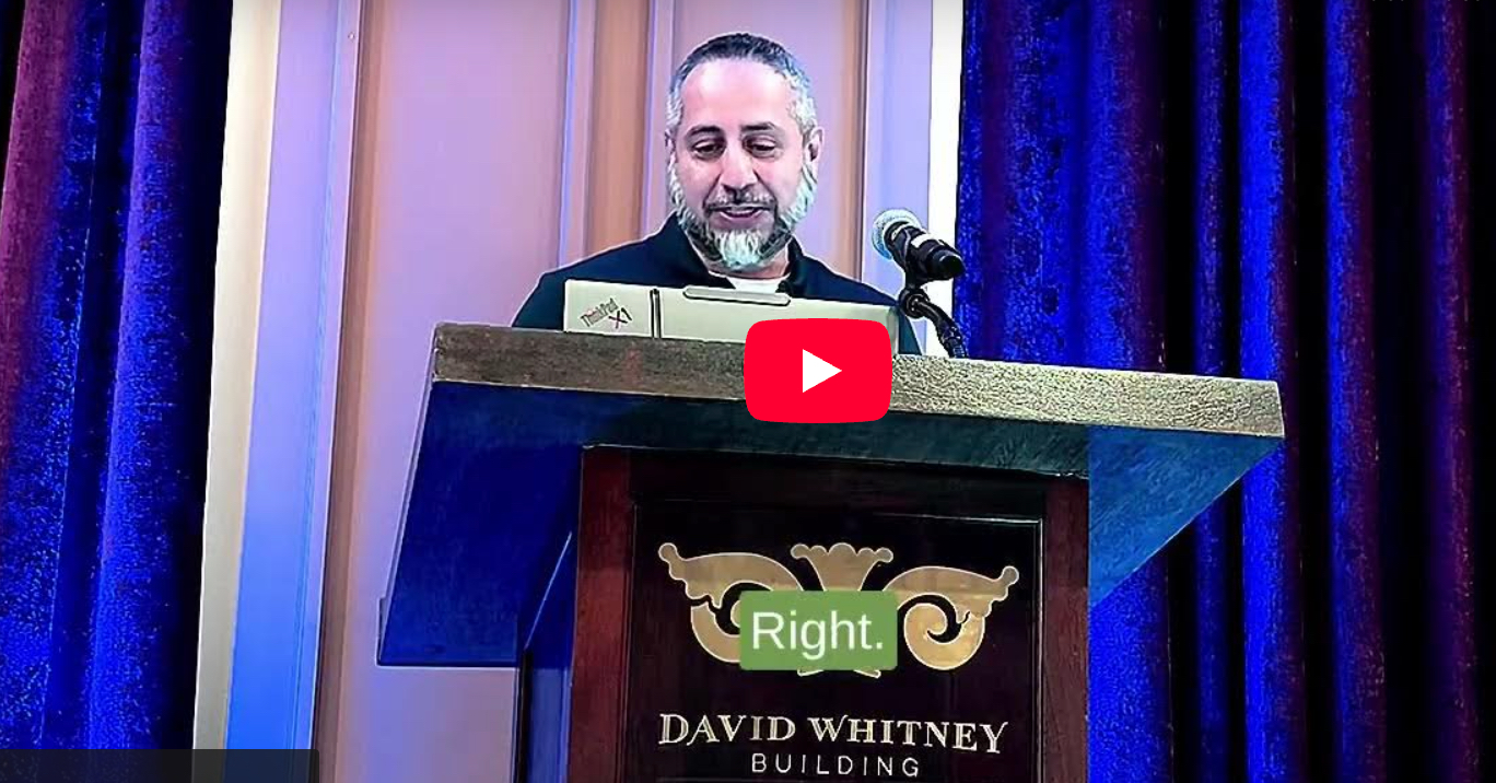 Mustansir Saifuddin at lectern